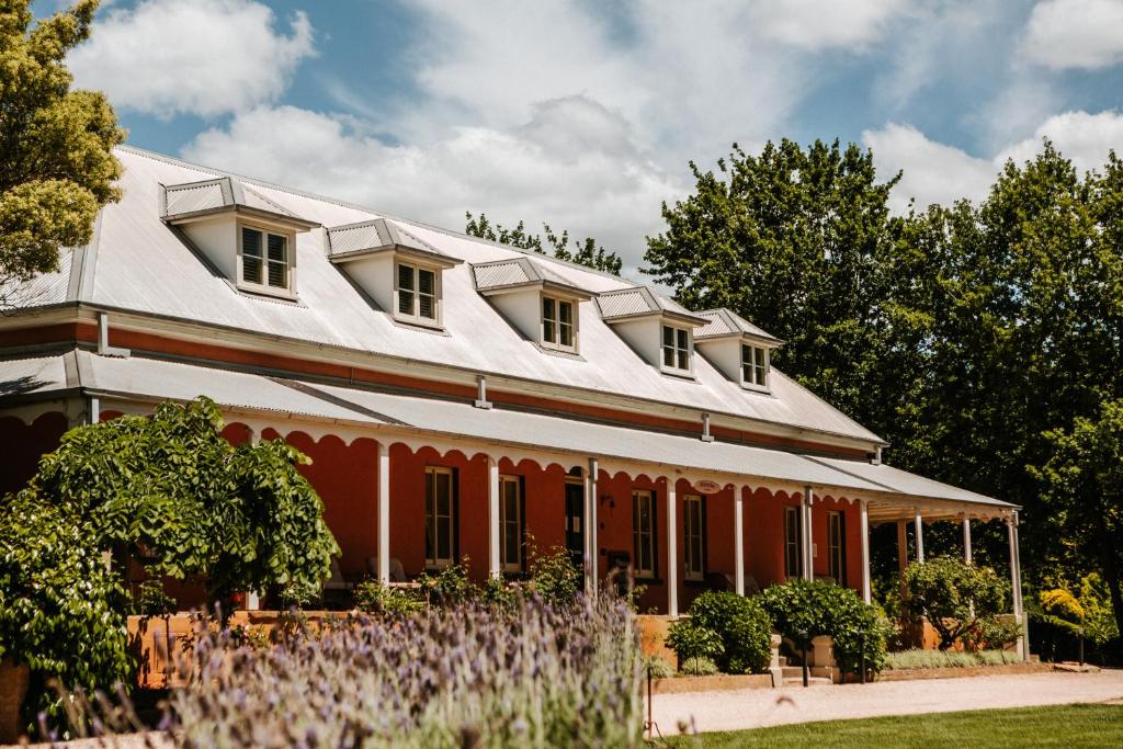 a large red house with a white roof at Fitzroy Inn Historic Retreat Mittagong in Mittagong