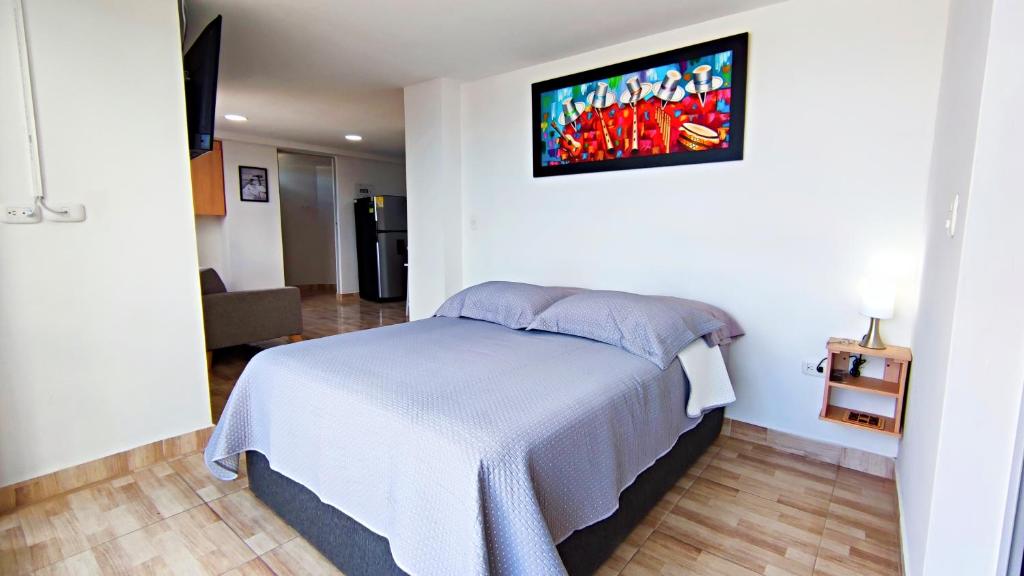 a bedroom with a bed and a tv on the wall at Villa Quintero202 in Santa Rosa de Cabal