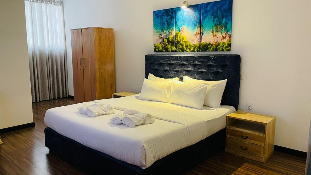Postel nebo postele na pokoji v ubytování Beverly Beach Mirissa