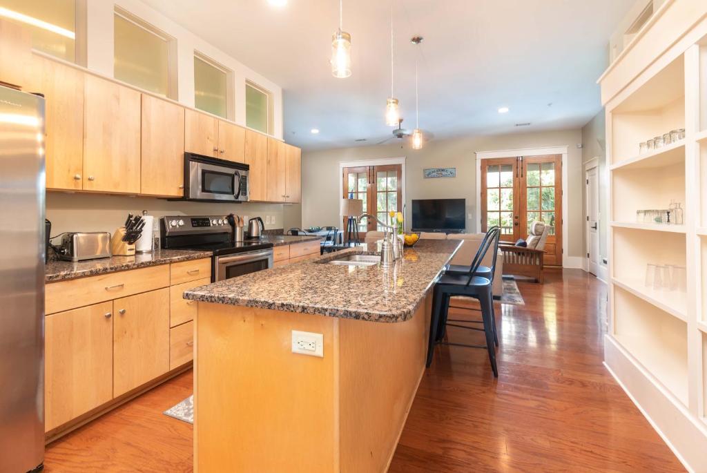 a kitchen with wooden cabinets and a counter top at Cherokee Farms Flat - New Listing in Habersham in Beaufort