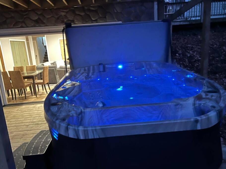 a blue hot tub sitting on a deck with a table at Emerald Shores in Coloma