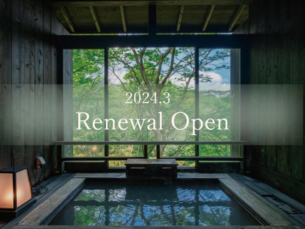 a swimming pool with a window with the words renewal open at Nagominoyado Hanagokoro - Reopening in Mar 2024 in Hakone