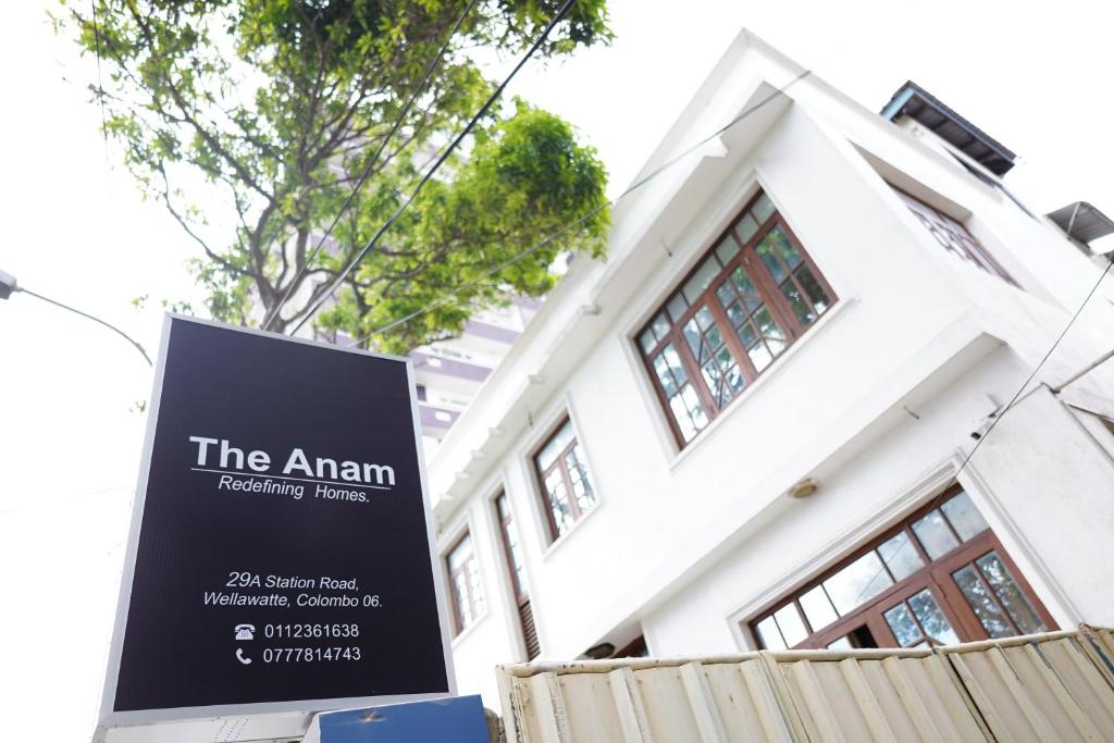 a sign in front of a building at The Anam Hostel in Colombo