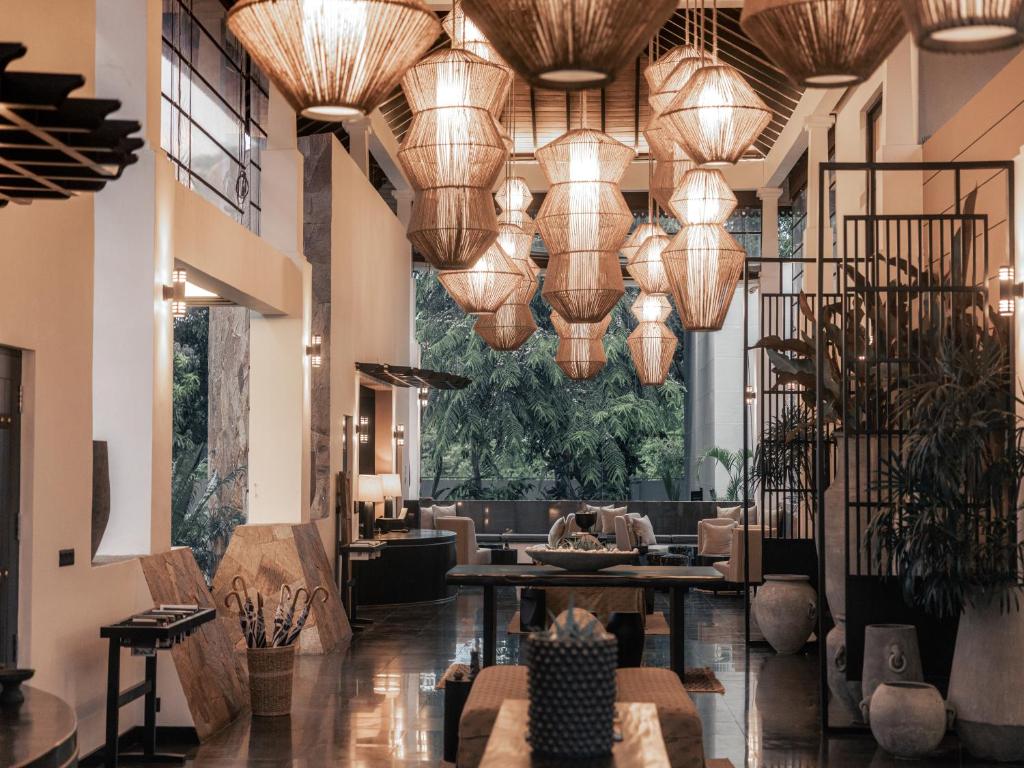 a lobby of a hotel with large chandeliers at Sun Siyam Pasikudah in Pasikuda