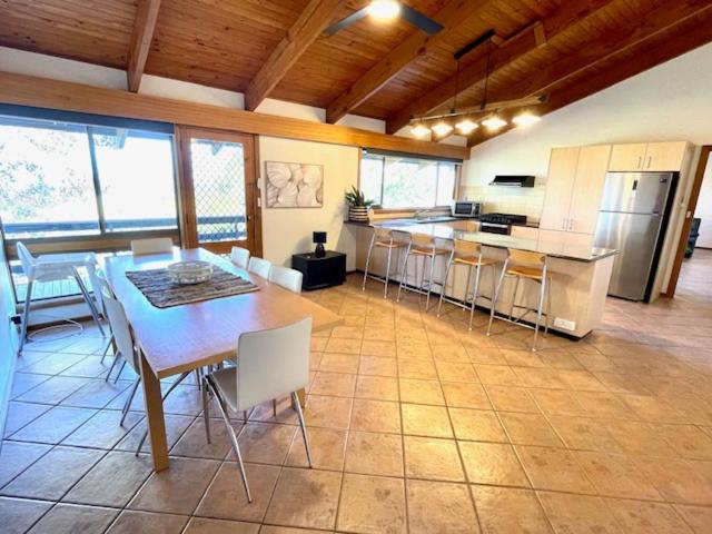 a kitchen and dining room with a table and chairs at Cooinda Holiday Village House in American River