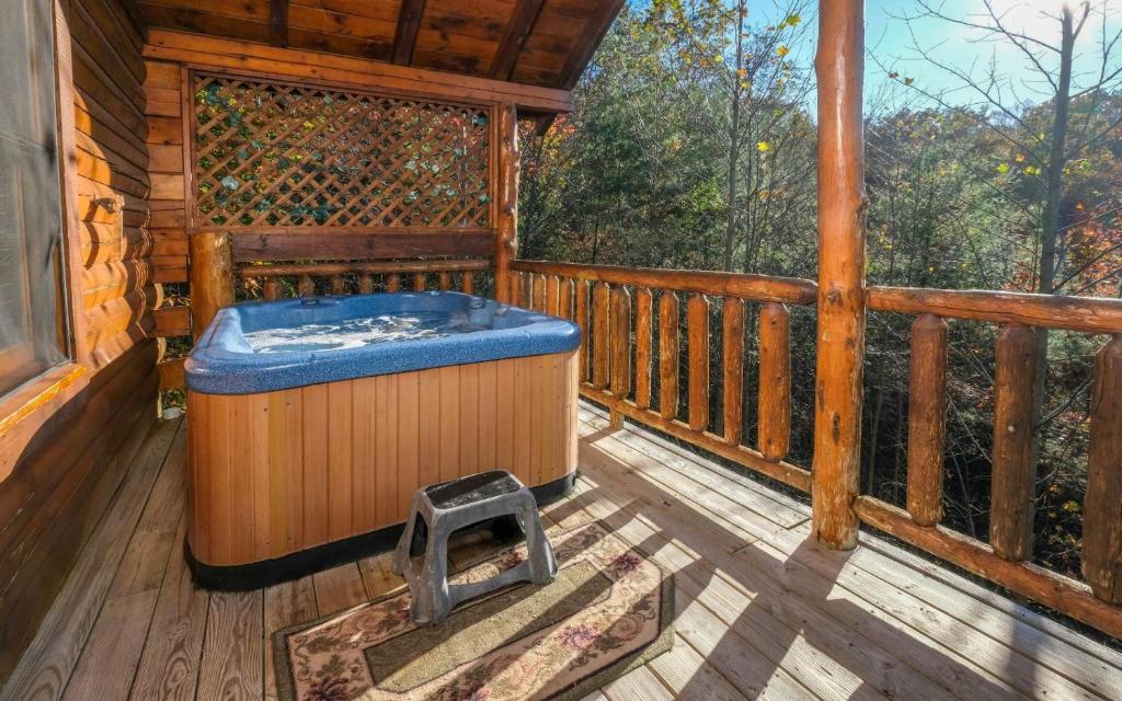 a hot tub on the deck of a cabin at First Flight in Sevierville