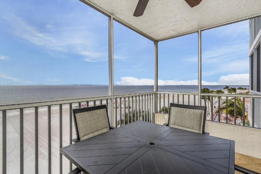 a table and chairs on a balcony with a view of the beach at Welcome to Beach Villa's # 405 Vacation Rental - 250 Estero Blvd condo in Fort Myers Beach