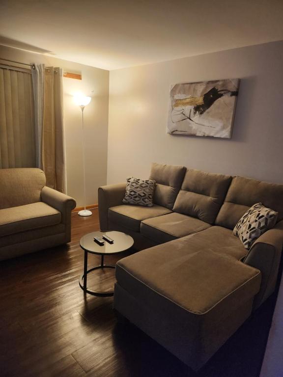 a living room with a couch and a table at private upper 1 bd apartment in Buffalo