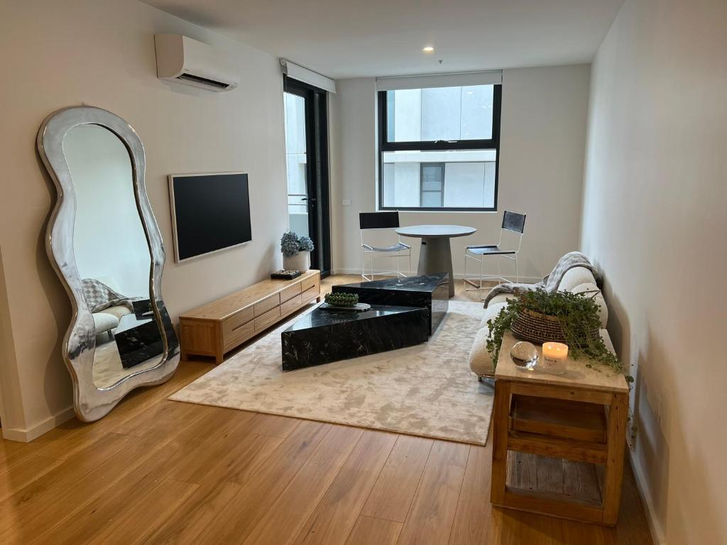 a living room with a mirror and a table at NEW BOUTIQUE 1bd Apt in Canberra