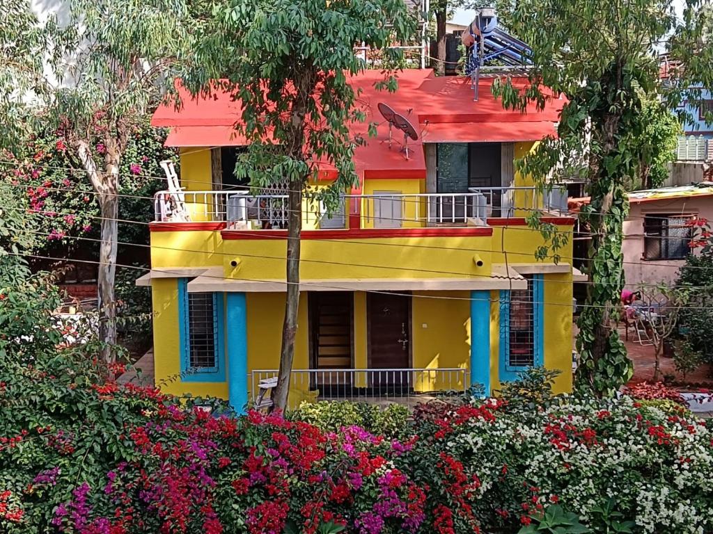 a colorful house with flowers in front of it at Om Bungalow -Happy Stay At Panchgani in Panchgani