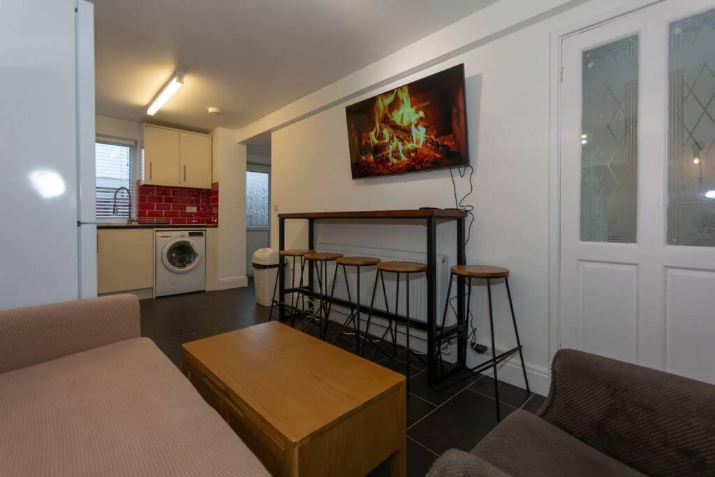 a living room with a couch and a table at BrumStay UK® 5-Bed House Ideal for Long-Term Stays in Birmingham