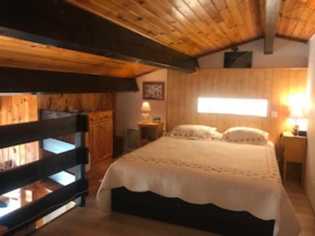 a bedroom with a large bed and a wooden ceiling at VENTOUX 21 in Enchastrayes