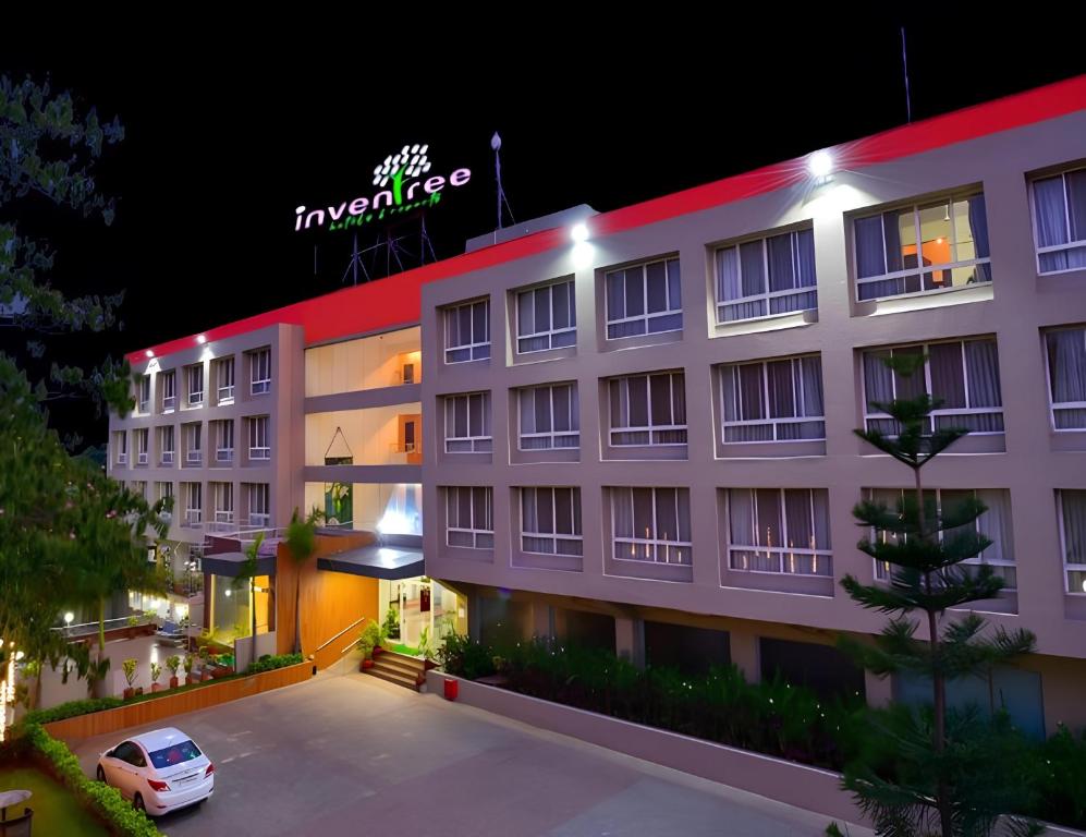 a hotel with a car parked in front of it at Inventree Hotel Pune in Pune