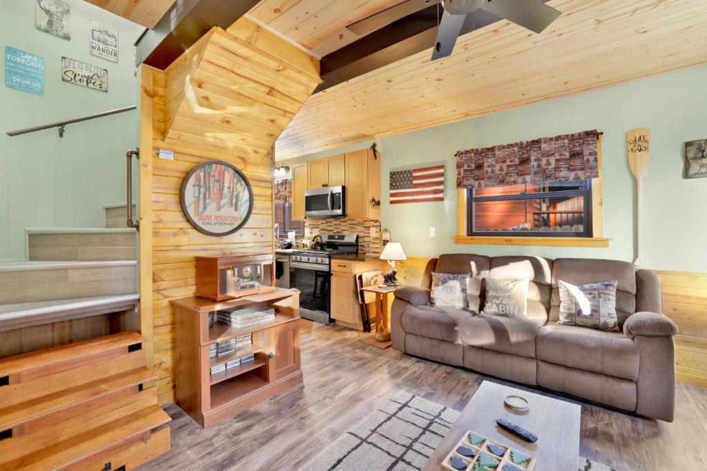 a living room with a couch and a kitchen at 2387- Hidden Loft Chalet cabin in Big Bear City