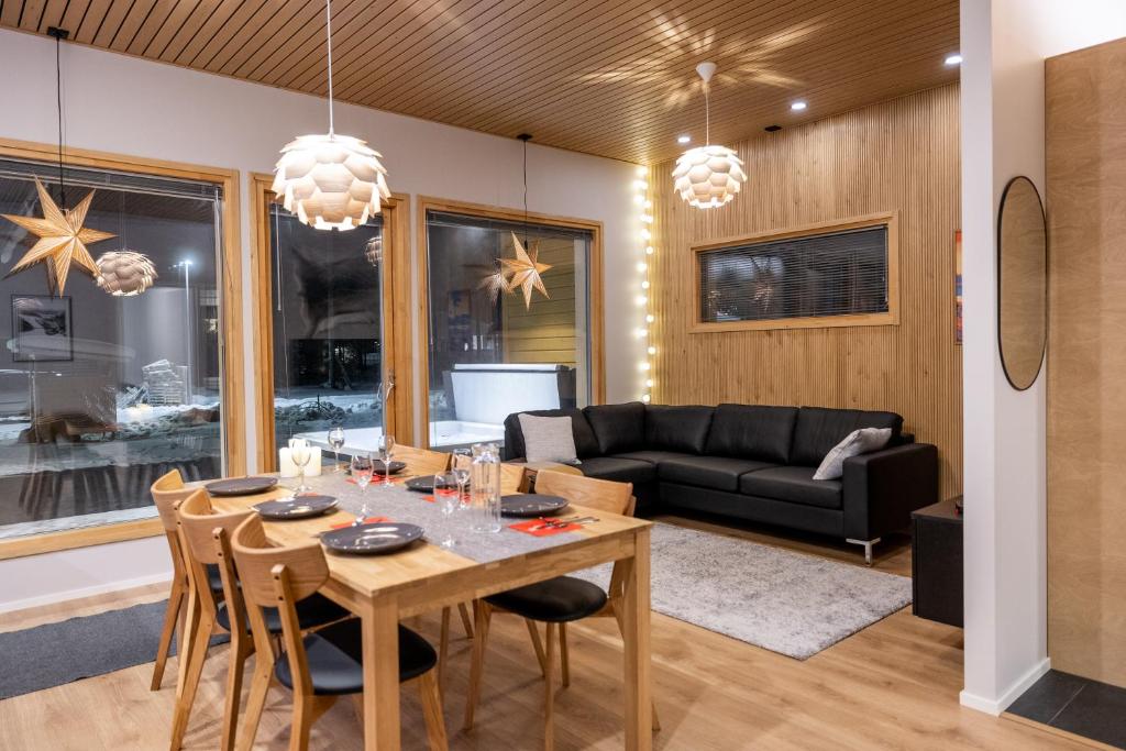 a living room with a table and a couch at Villa Blueberry in Rovaniemi