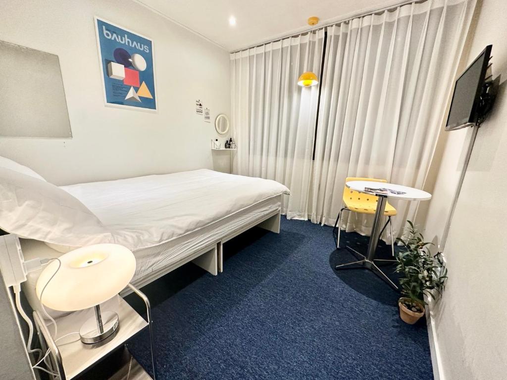 a hospital room with a bed and a tv at SSH Ikseon peter cat Hostel in Seoul