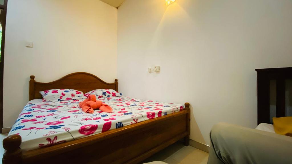 a bedroom with a bed with a stuffed animal on it at Thambapanni safari hostel in Moragaswewa