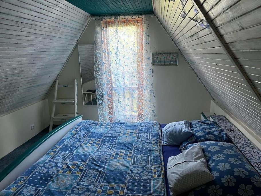 a bedroom with a bed and a window at Chata se zahradou v Liberci in Liberec