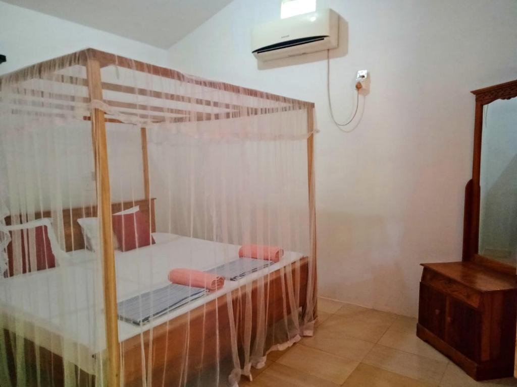 Postel nebo postele na pokoji v ubytování Arachchi Guest House