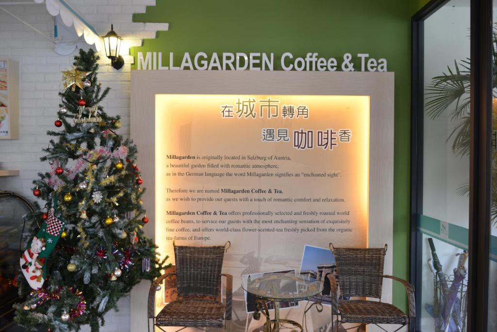 a sign in a window with a christmas tree at Taitung Venice B&B in Taitung City
