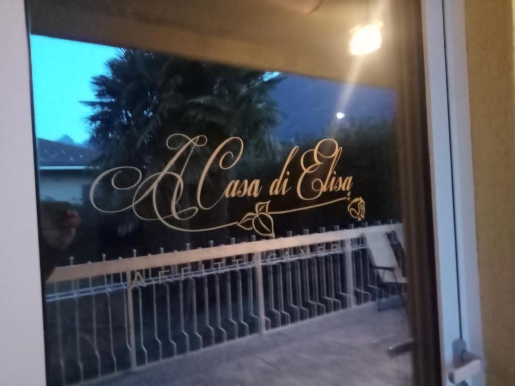 a glass window with a sign on a balcony at La Casa di Elisa Affittacamere in Gravellona Toce