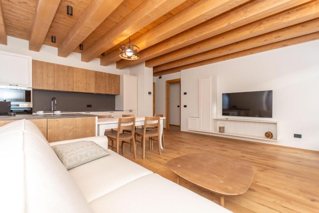 a living room with a white couch and a table at Villa Caterina in Falcade