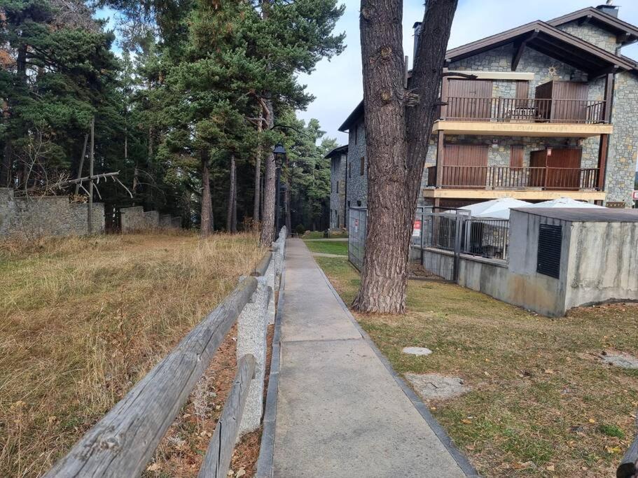 a sidewalk in front of a house with a tree at Piso Acogedor en La Molina in La Molina