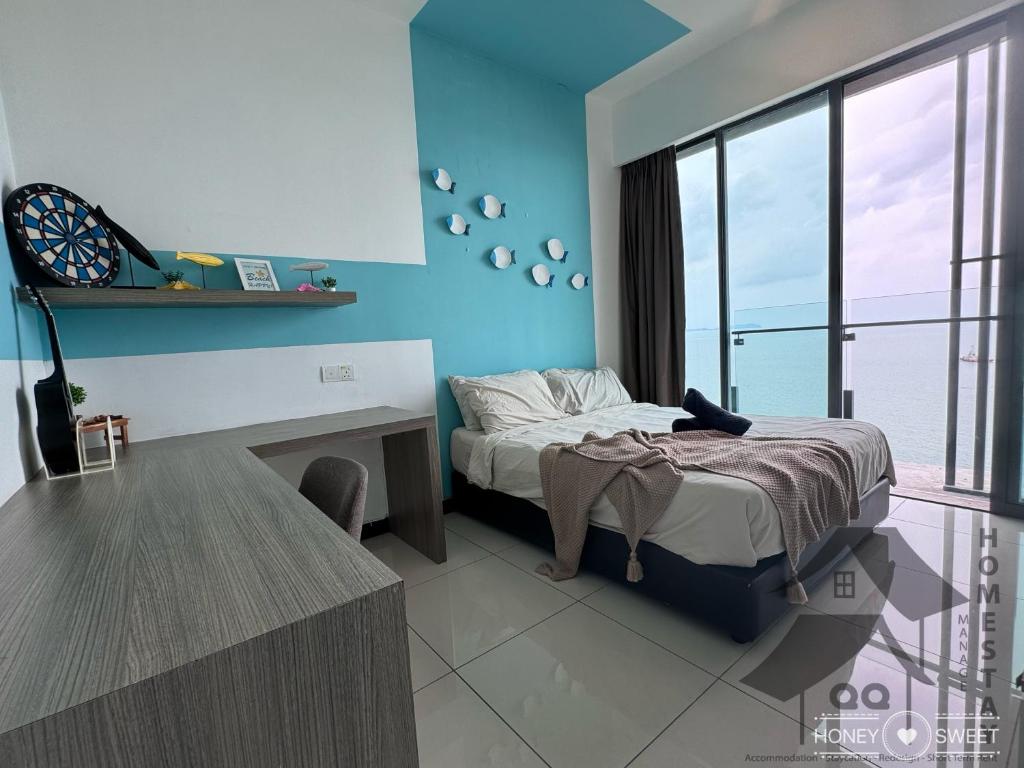 a bedroom with a bed with a desk and a window at Full Seaview 3BR 3BD Duplex Apartment 房间全面向海景-3房 3卫 复式公寓 in Port Dickson