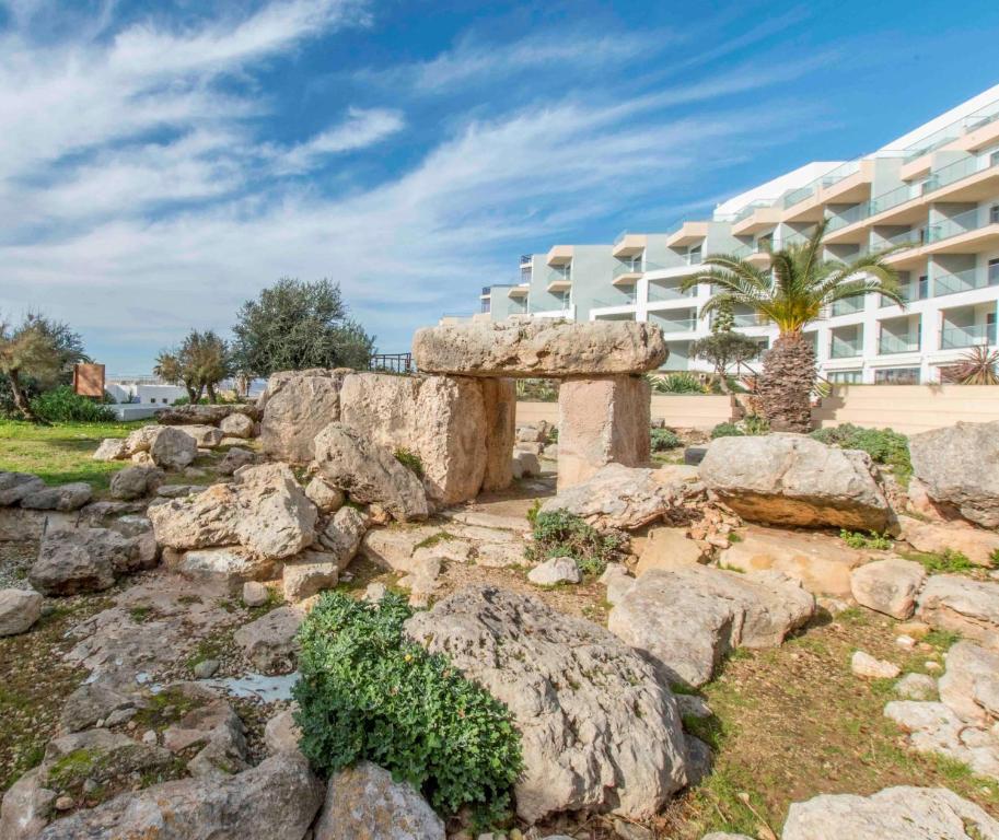a rock garden in front of a building at DoubleTree by Hilton Malta in St Paul's Bay