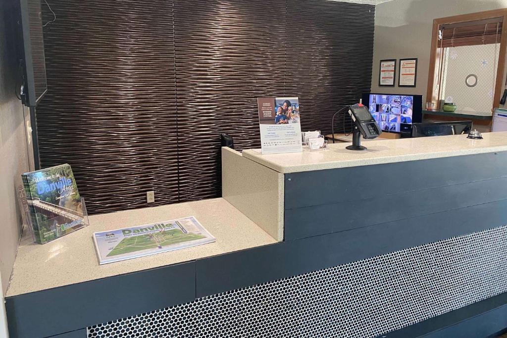 a reception counter in a office with a phone at Baymont by Wyndham Danville IL in Danville