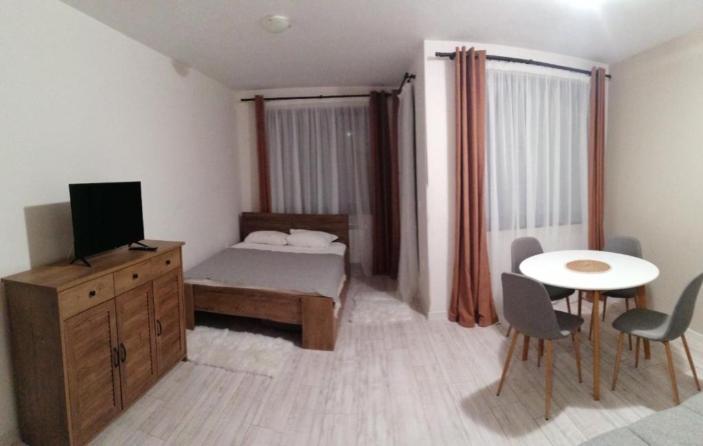 a small bedroom with a bed and a table and chairs at Apartment B45 Borovets Gardans in Borovets