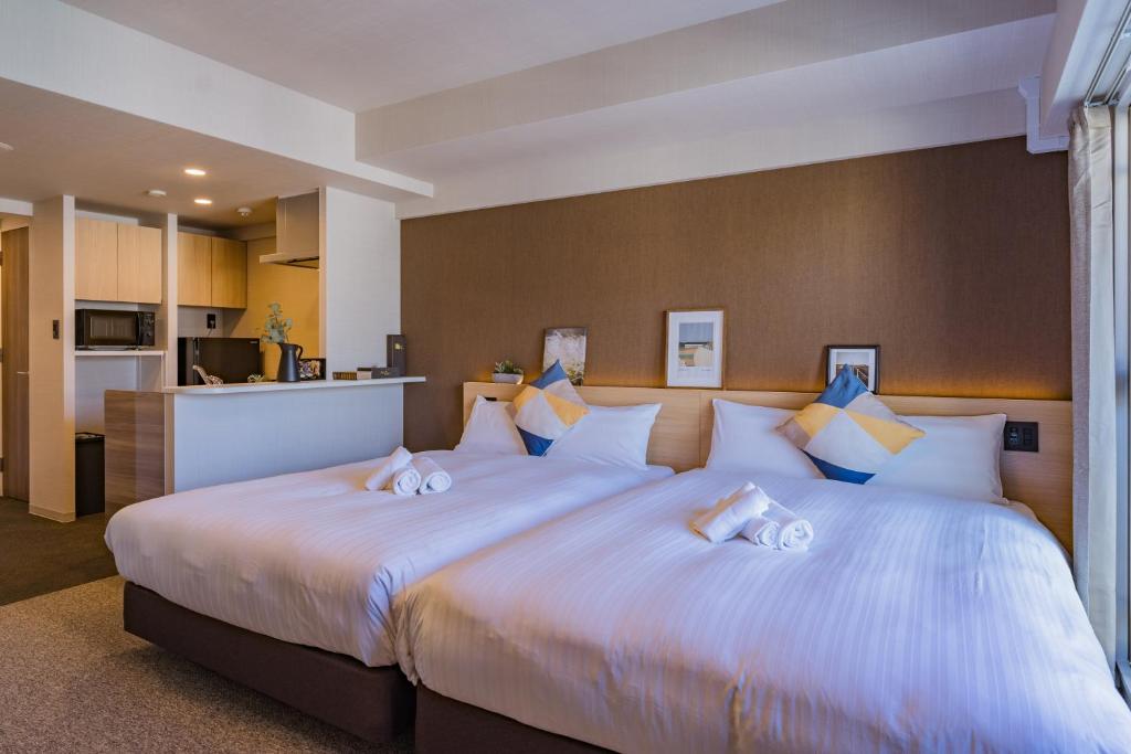 Postel nebo postele na pokoji v ubytování Apartment Hotel 11 Shinsaibashi 3