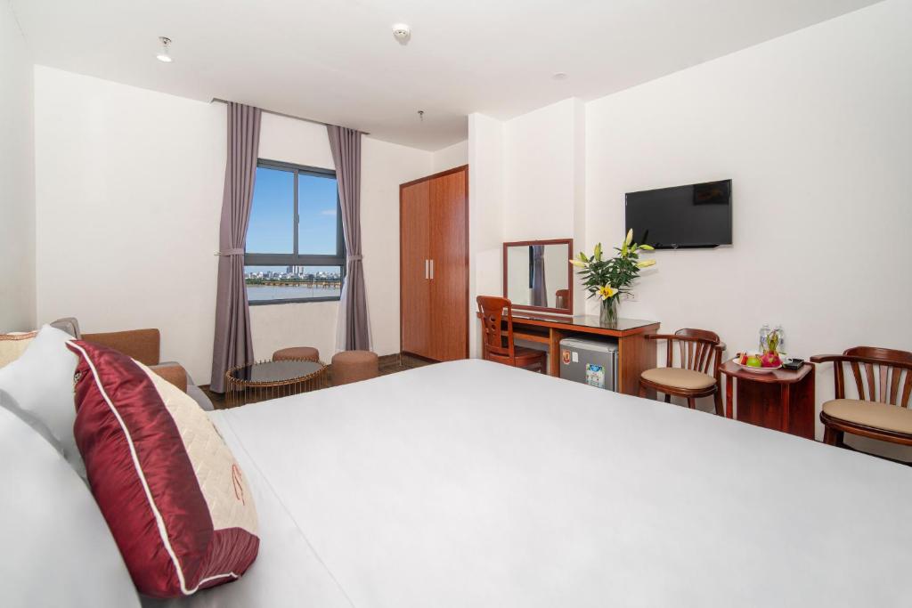 Postel nebo postele na pokoji v ubytování Phú An Hotel