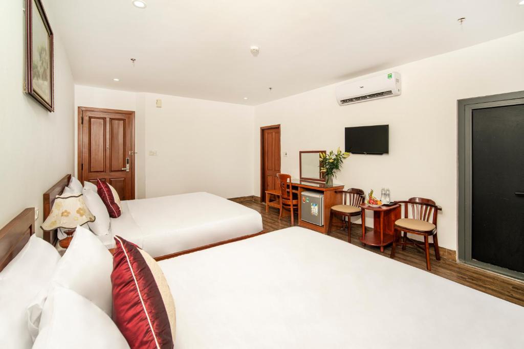 Postel nebo postele na pokoji v ubytování Phú An Hotel