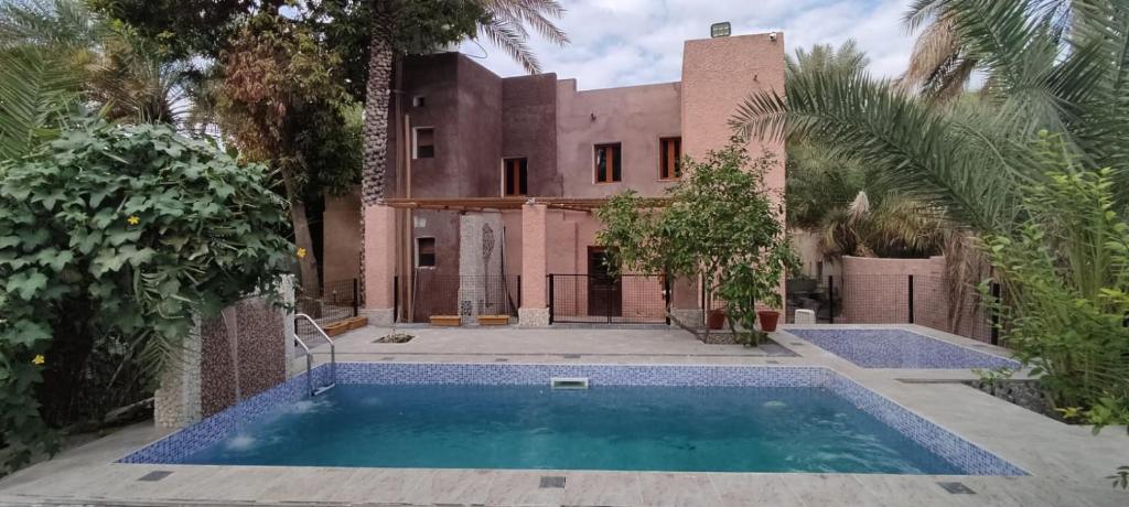 an exterior view of a house with a swimming pool at Riad Nizwa in Nizwa