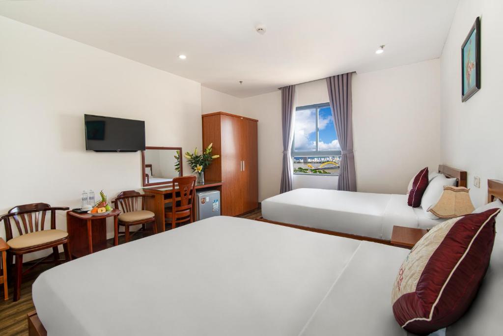 Postel nebo postele na pokoji v ubytování Phú An Hotel