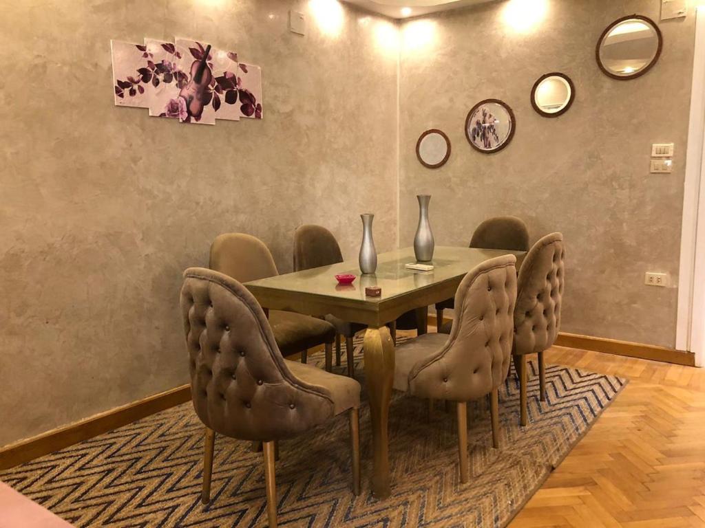 a dining room with a table and chairs at Luxury apartment in Mohandiseen in Cairo