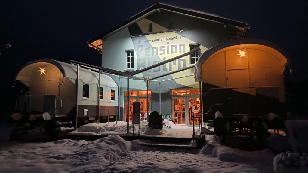 a building in the snow at night at Weltraumbahnhof Rautenkranz - Steampunk Hotel in Muldenhammer