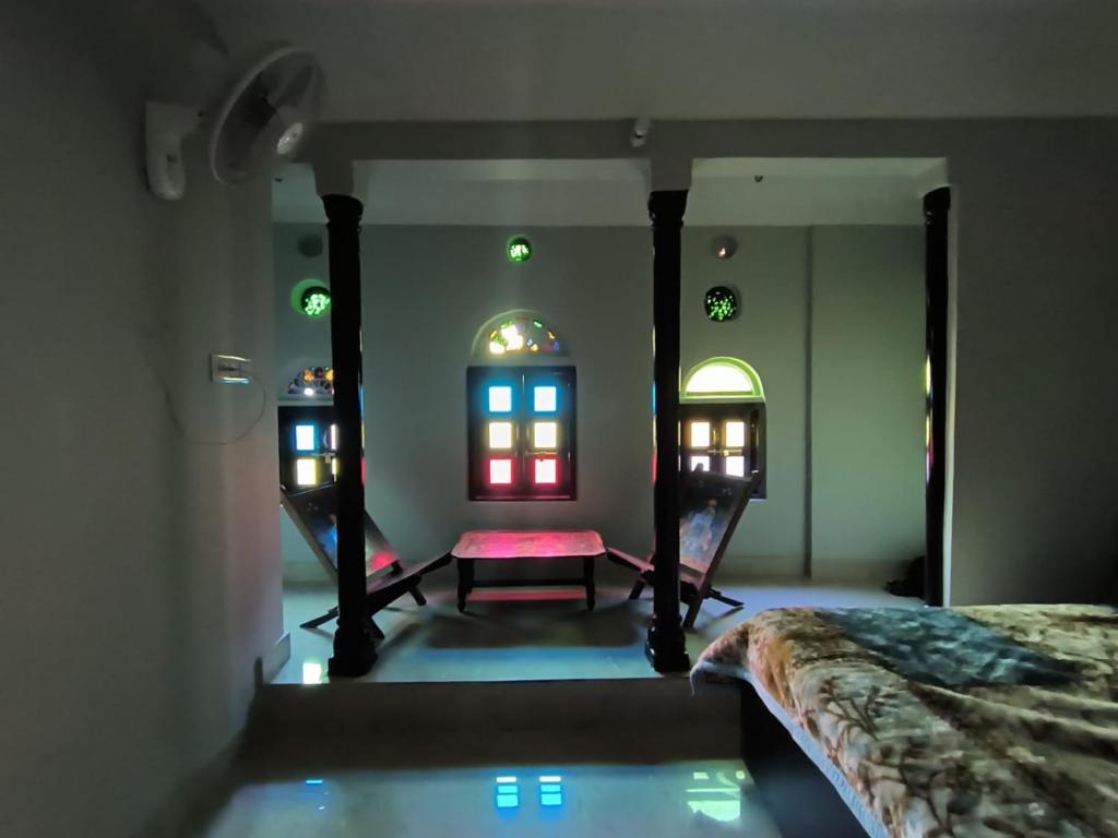 a room with a bed and two mirrors at Pink City Backpackers in Jaipur