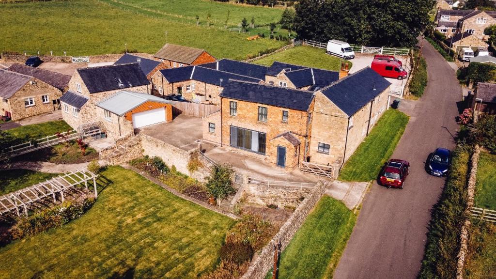 an aerial view of a large house with cars on a road at Cottages In Derbyshire, The Farm House in Belper