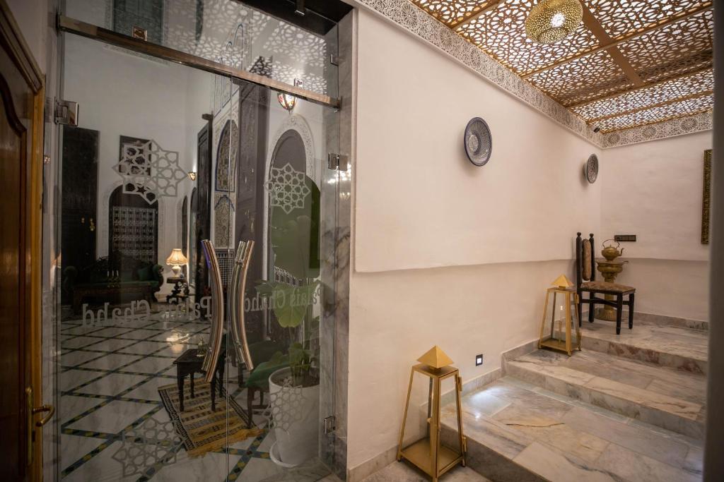 a room with a glass door with a table and chairs at Palais Chahd Luxury in Fez