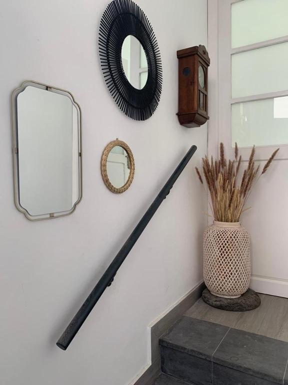 a hallway with a mirror and a vase on the stairs at Meriga in Agulo