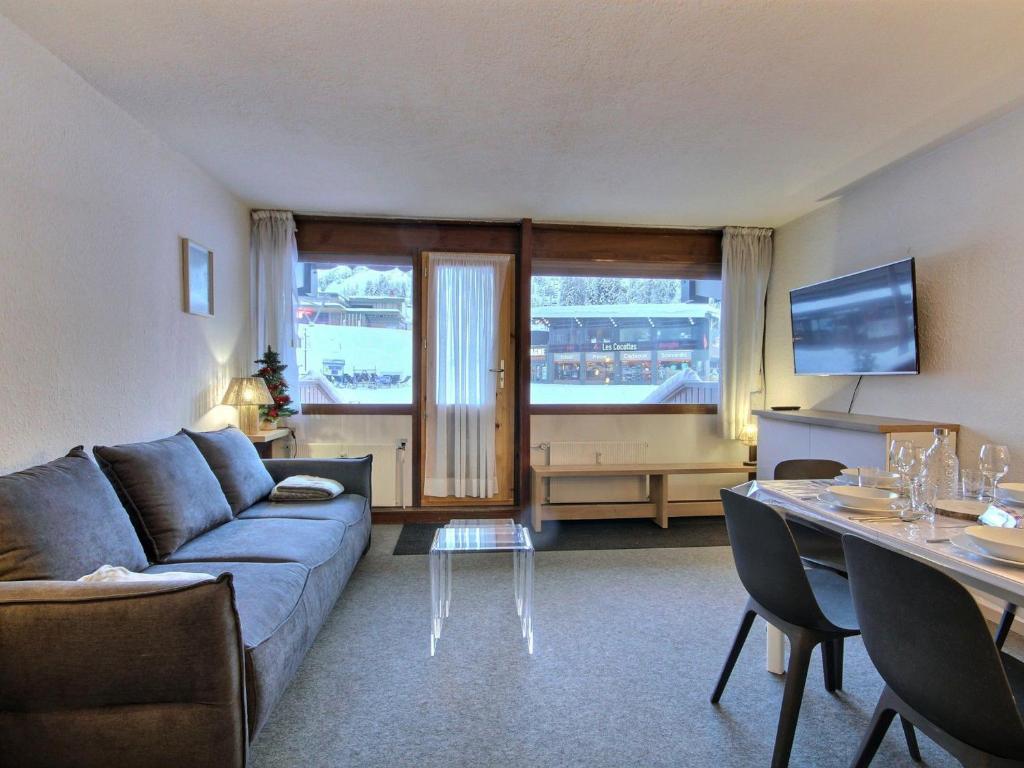 a living room with a couch and a table at Appartement La Plagne, 3 pièces, 6 personnes - FR-1-455-244 in La Plagne Tarentaise