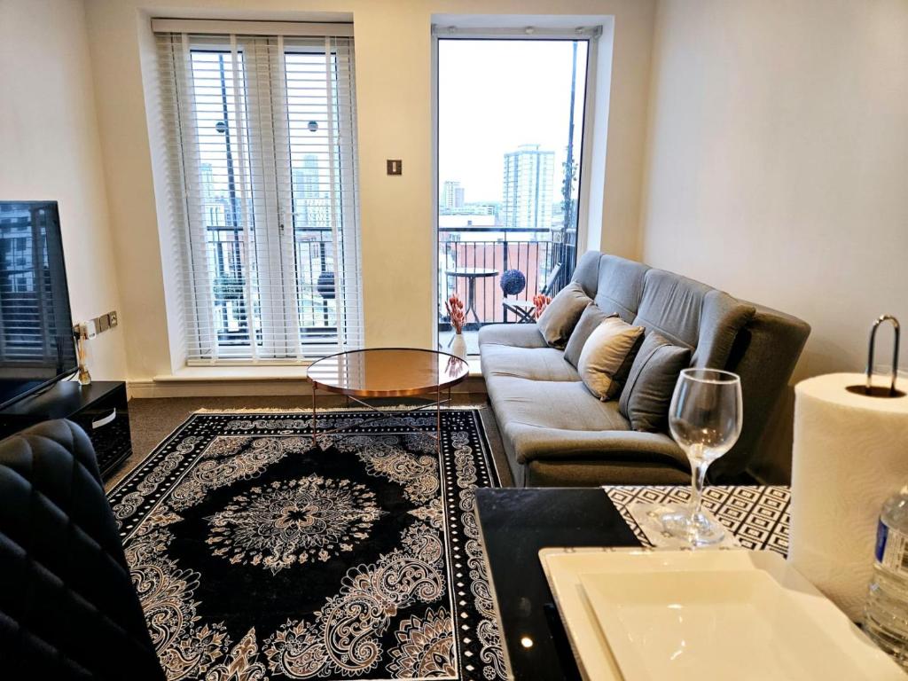 a living room with a couch and a table at Cozzy Stay in London