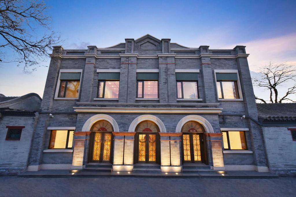 a large stone building with its lights on at Dongsi No 78 Boutique Apartment in Beijing