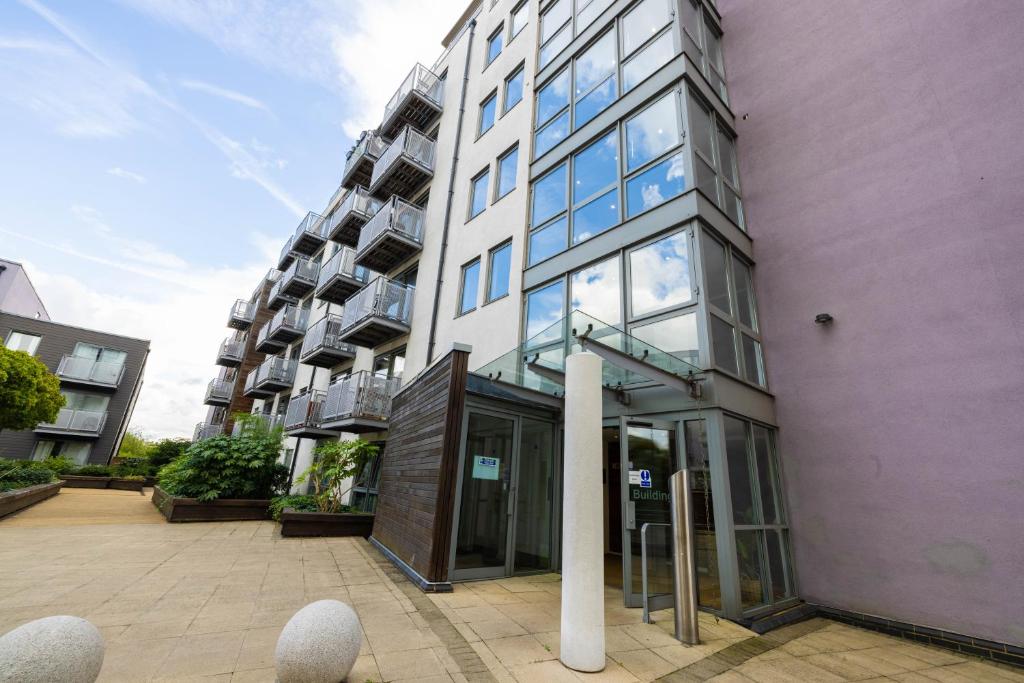 a tall white building with glass doors in a city at Beautiful and spacious 2-Bed Apartment in London in London