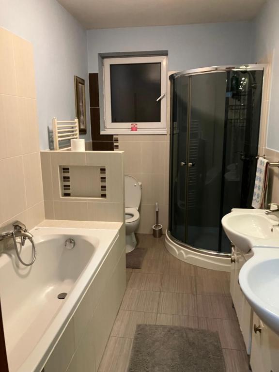 a bathroom with a tub and a toilet and a sink at Kosice ubytovanie v rodinnom dome in Košice