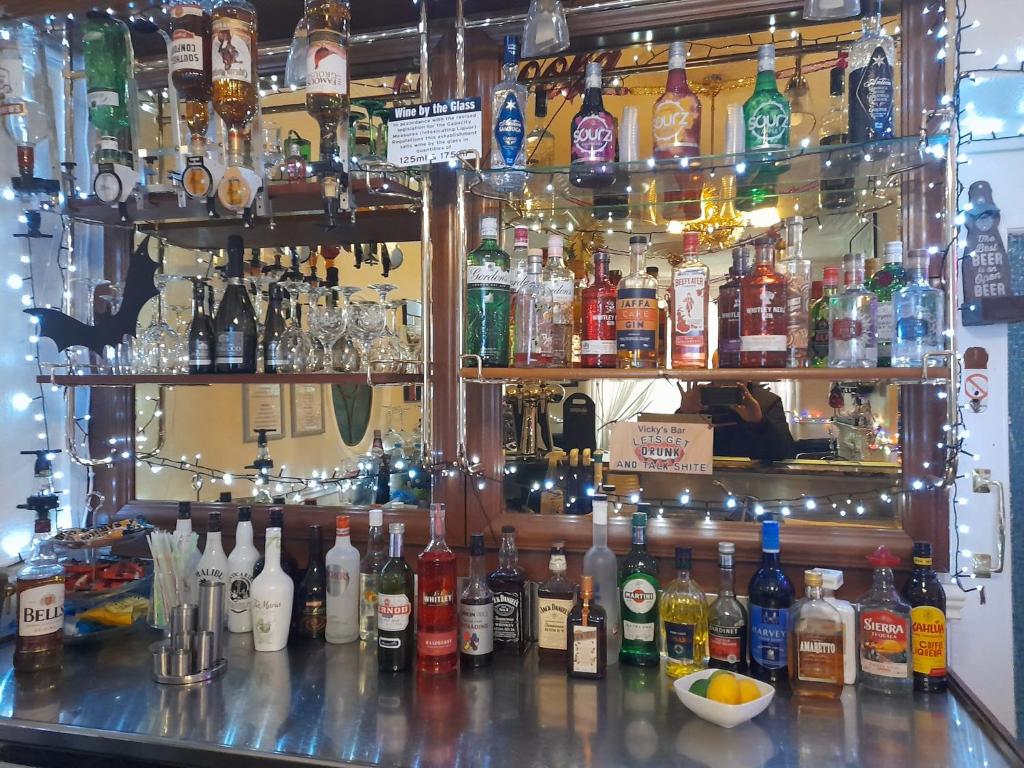 a bar filled with lots of bottles of alcohol at Riversvale Hotel in Blackpool