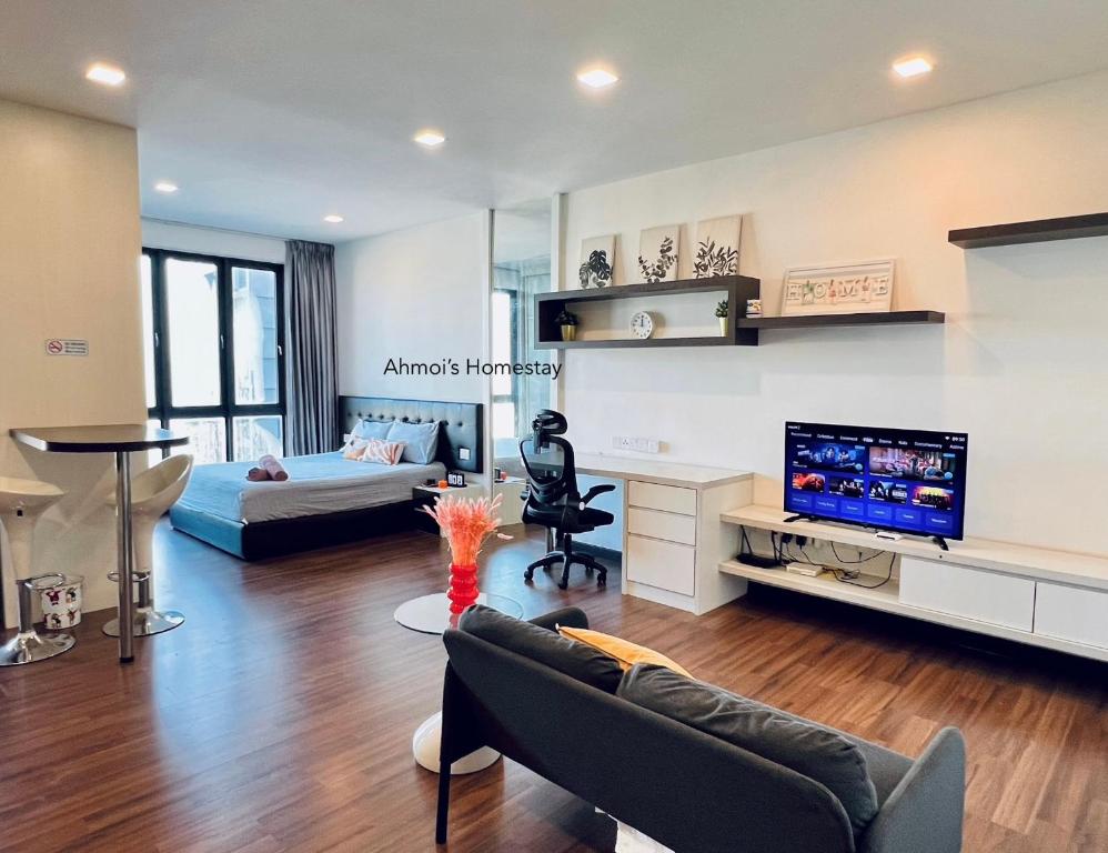 a living room with a couch and a tv at Silk Sky Residence, Pool View, High Speed Wi-Fi, TVBox, C180, Cheras, C180, Aeon Cheras Selatan, Balakong in Seri Kembangan