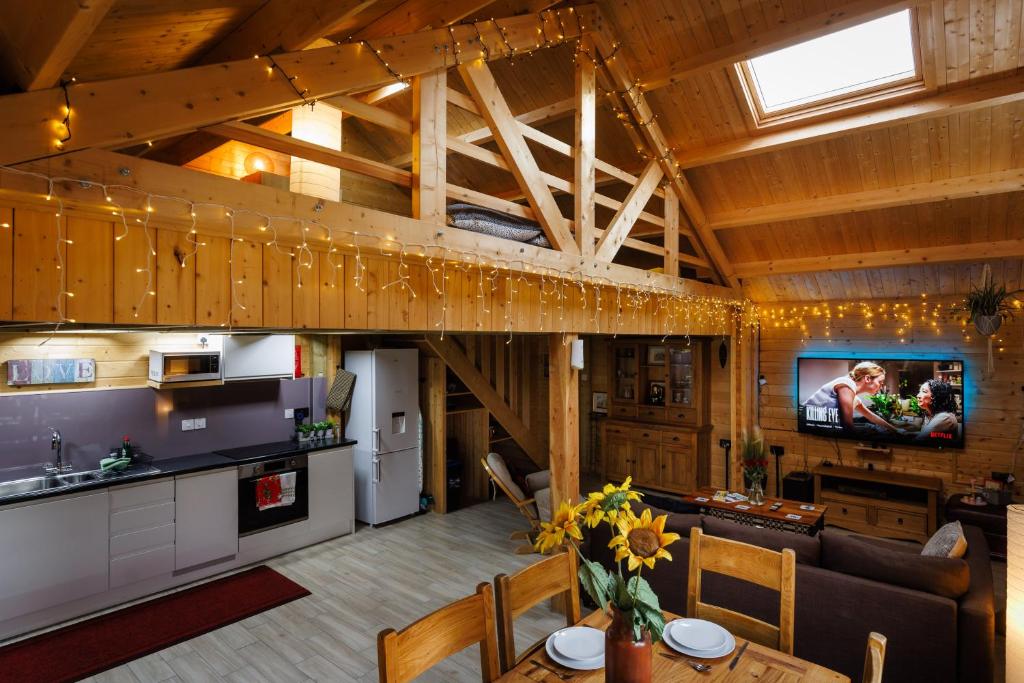una cucina a pianta aperta e un soggiorno in una casa di Cosy Log Cabin with Parking near Cambridge a Cambridge